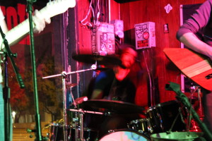 A drummer rocking out on stage. 